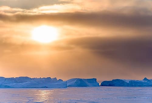 Sunset during winter at the Ilulissat Fjord-located in the Disko Bay in West Greenland Art Print